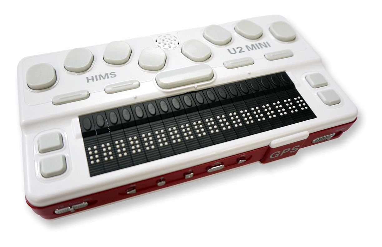 Photo shows a white rectangular device about 8x10 inches and less than an inch thick.  It has 8 keys plus 9 other buttons and a braille display with 18 cells.