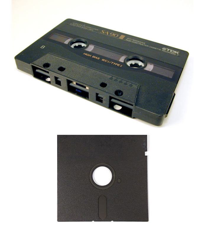 Photo shows a cassette tape and a black floppy disk.