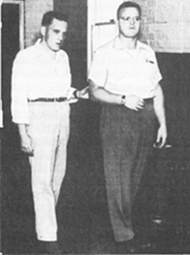 A soldier walks with his hand holding the elbow of instructor Eddie Meese.