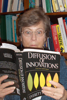 picture shows Dona looking amazed while reading the book