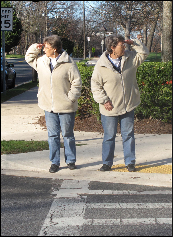 Photo shows a woman standing at a crosswalk and looking left while the same woman stands at the same crosswalk and looks right.