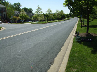 Photo shows a two-lane street that is straight, flat and visible for more than a block.