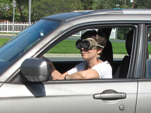 Photo shows Dona driving the car wearing occluders.